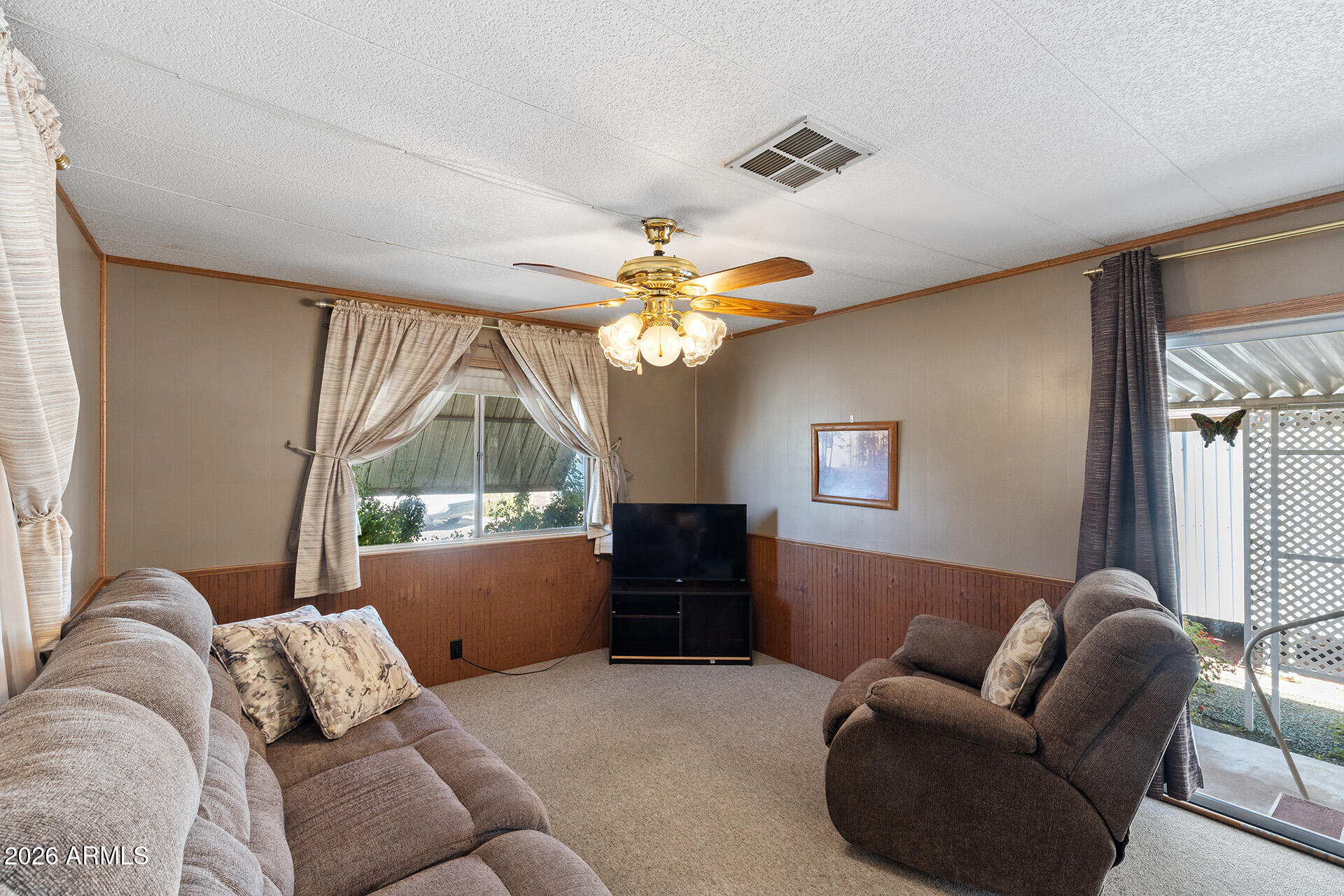 10540 East Apache Trail, Unit 151 Apache Junction, AZ 85120 - Photo 21 of 31 a living room with furniture and a large window