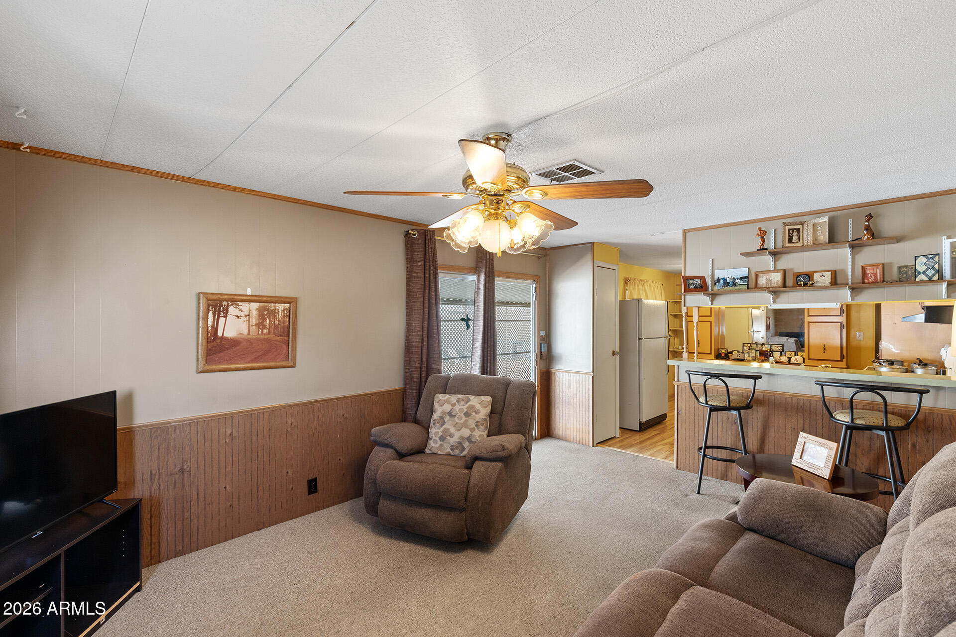10540 East Apache Trail, Unit 151 Apache Junction, AZ 85120 - Photo 22 of 31 a living room with furniture and a flat screen tv