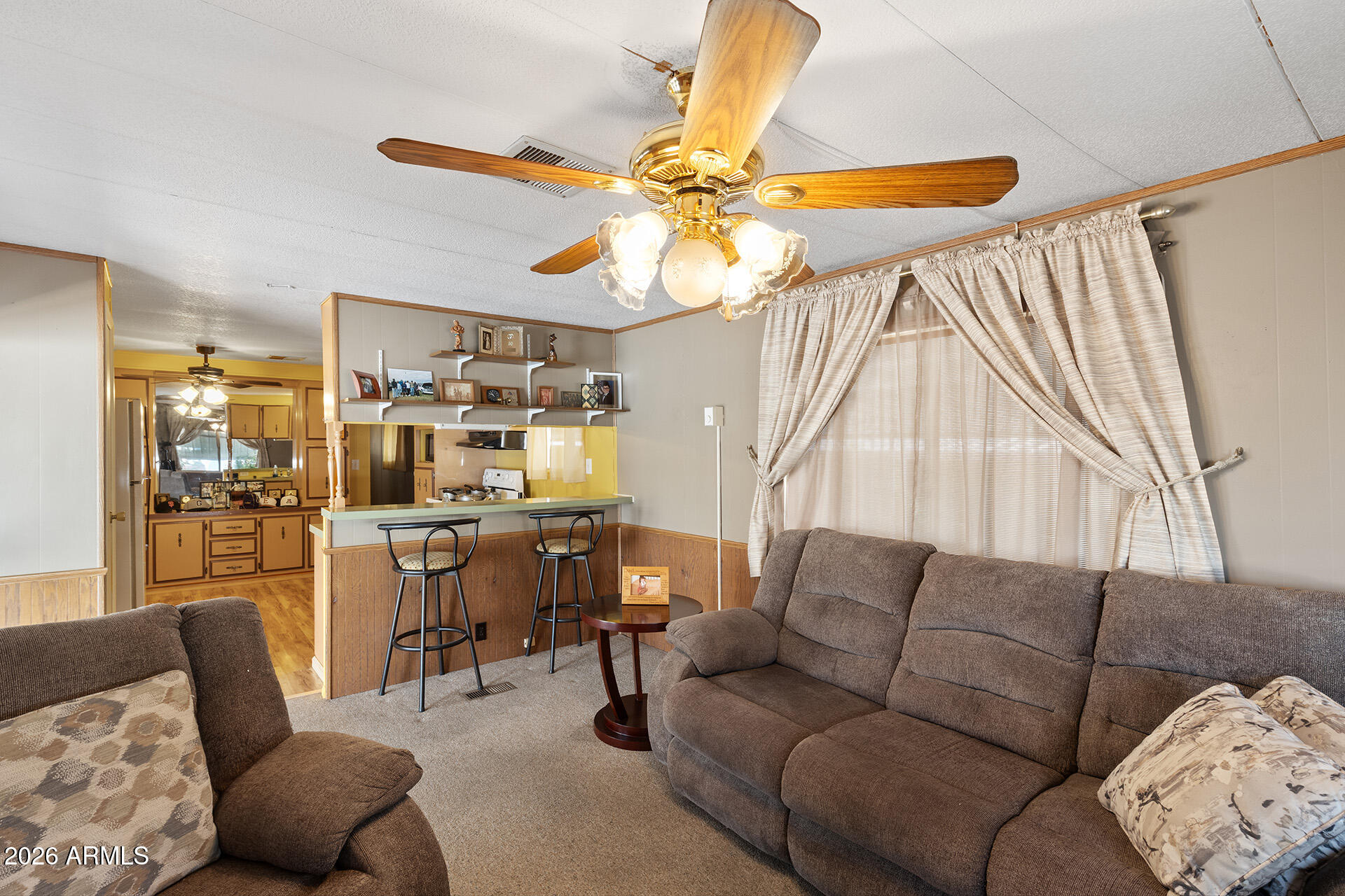 10540 East Apache Trail, Unit 151 Apache Junction, AZ 85120 - Photo 23 of 31 a living room with furniture and a dining table