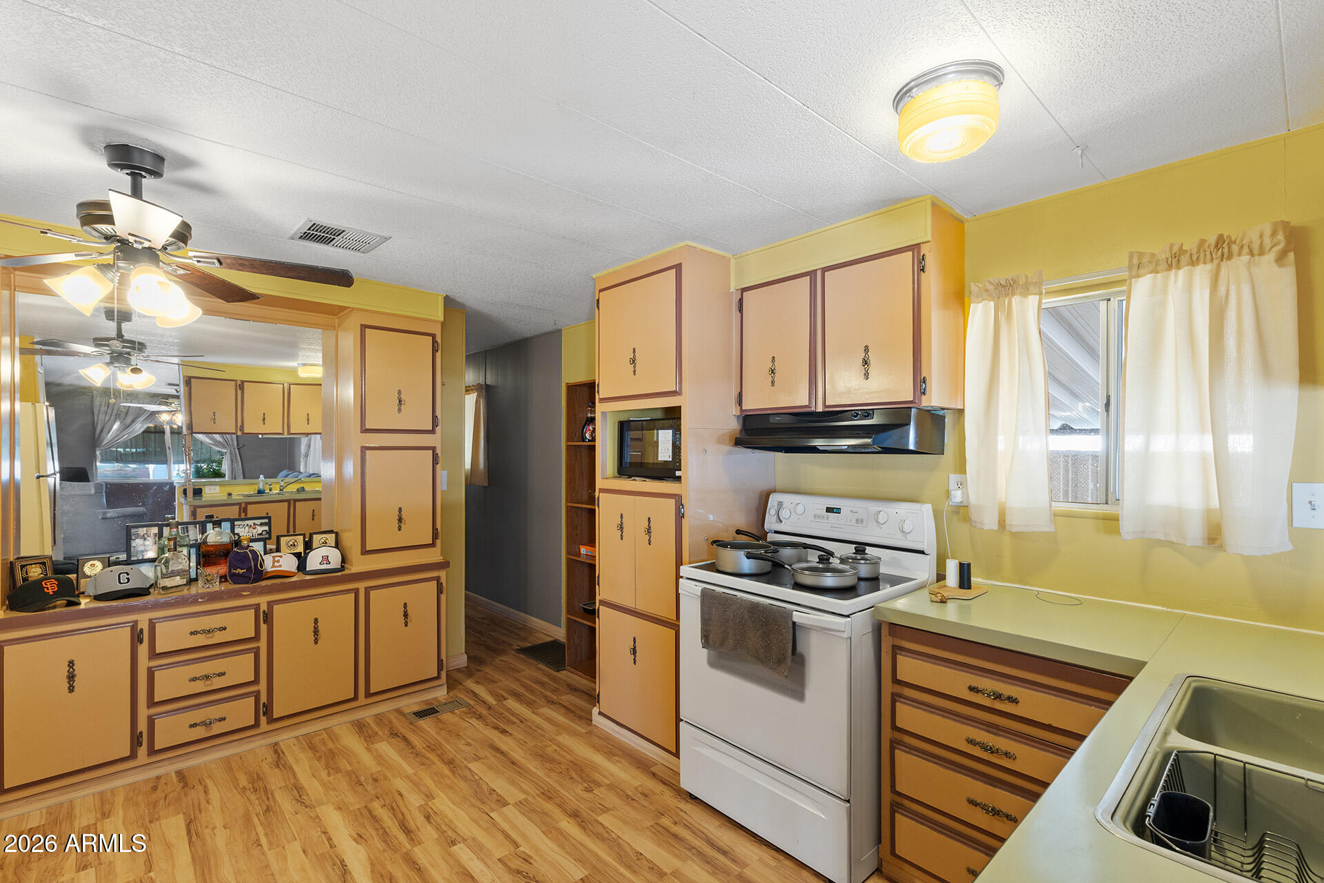 10540 East Apache Trail, Unit 151 Apache Junction, AZ 85120 - Photo 3 of 31 a kitchen with stainless steel appliances a stove a sink and a refrigerator