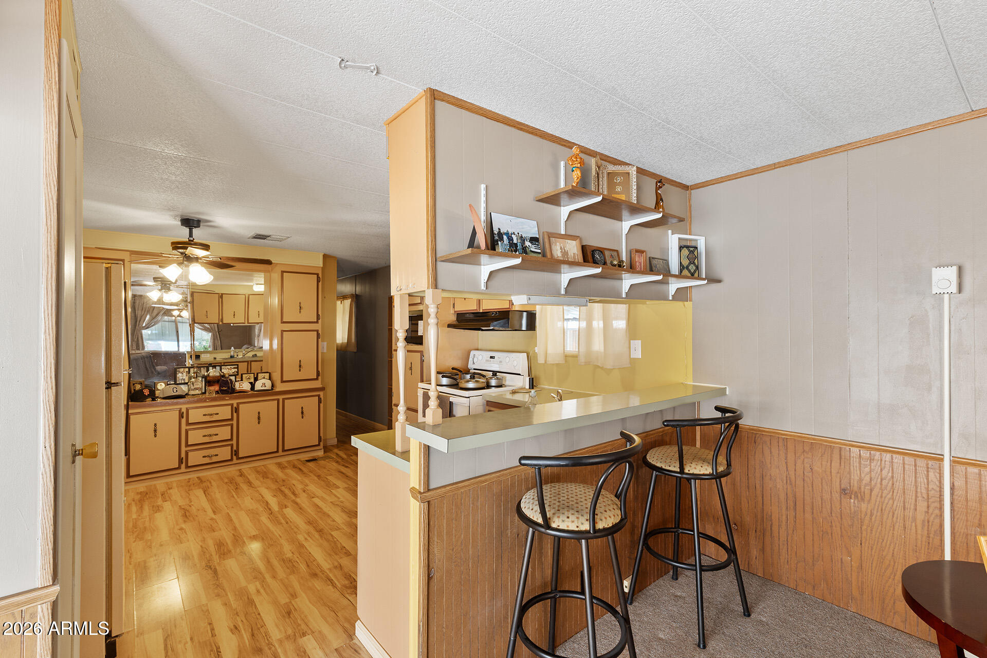 10540 East Apache Trail, Unit 151 Apache Junction, AZ 85120 - Photo 4 of 31 a kitchen with a table chairs refrigerator and cabinets