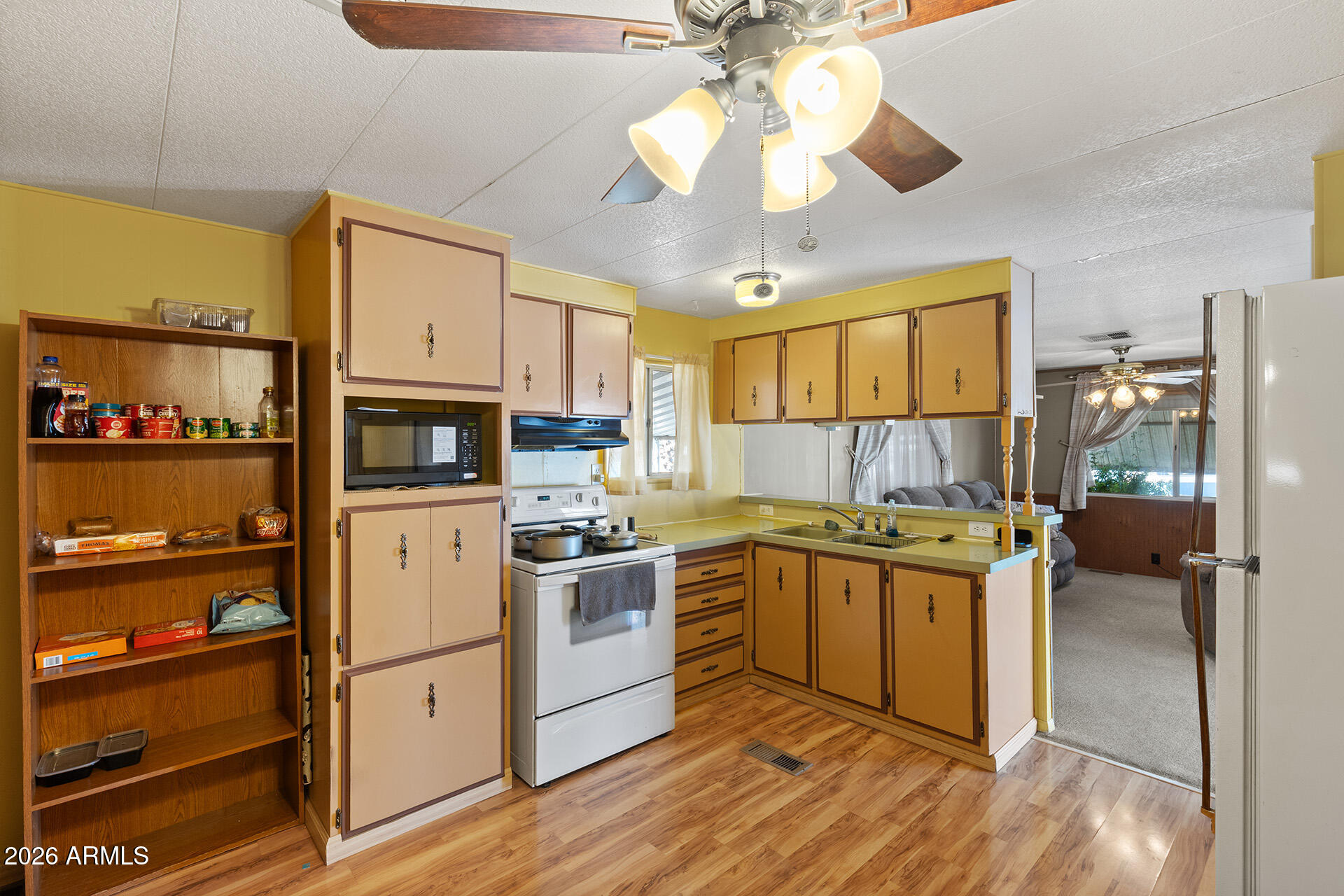 10540 East Apache Trail, Unit 151 Apache Junction, AZ 85120 - Photo 7 of 31 a kitchen with stainless steel appliances granite countertop a stove cabinets and wooden floor