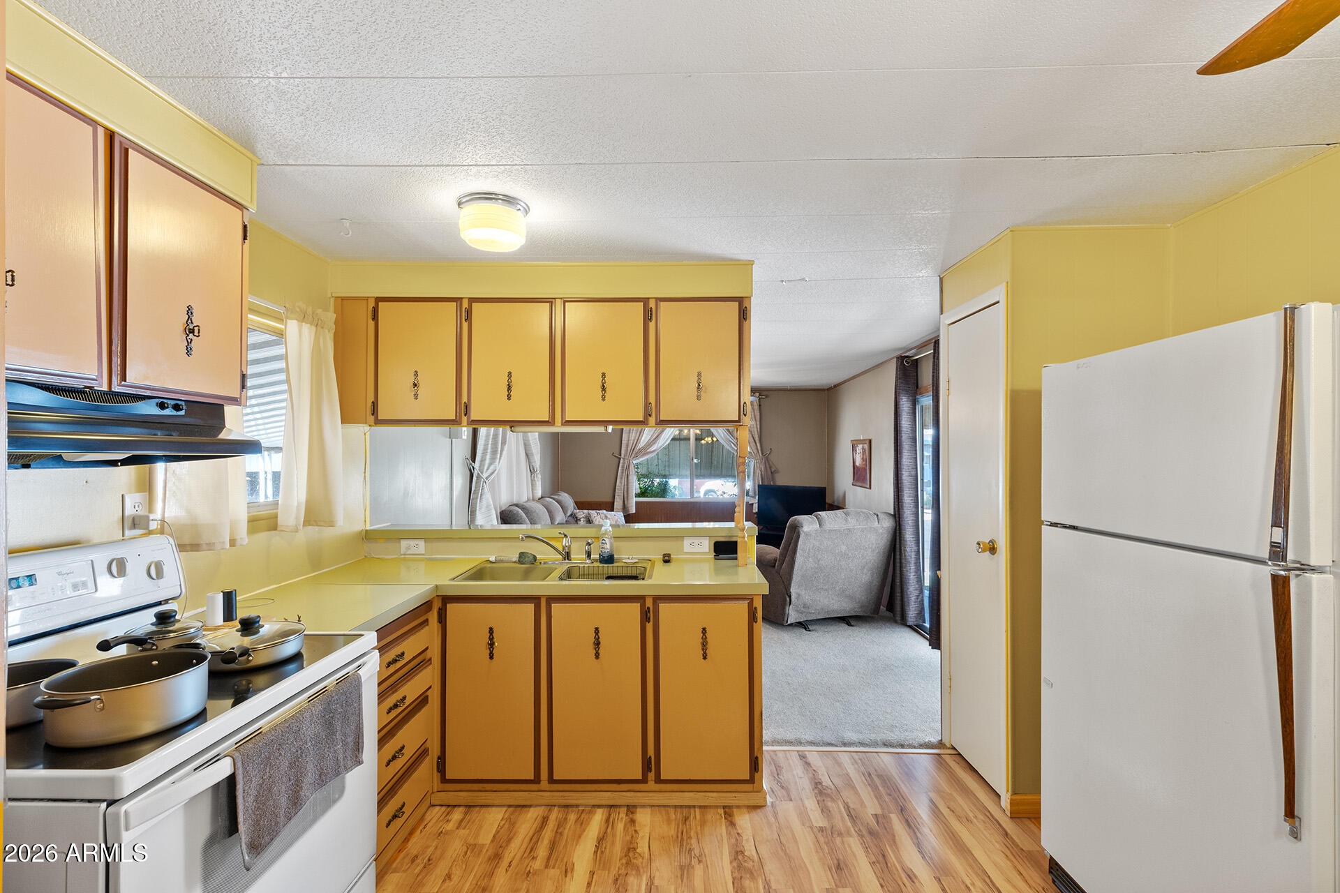 10540 East Apache Trail, Unit 151 Apache Junction, AZ 85120 - Photo 8 of 31 a kitchen with a stove a refrigerator and a refrigerator