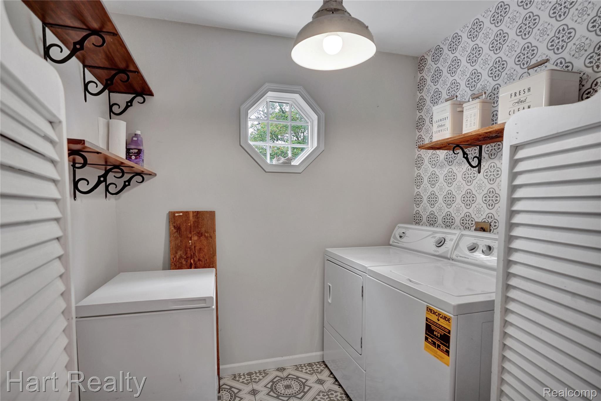 7167 Brown School Road North Branch, MI 48461 - Photo 27 of 51 Utility room featuring patterned floor tiles, an octagonal window, and white louvered bifold doors