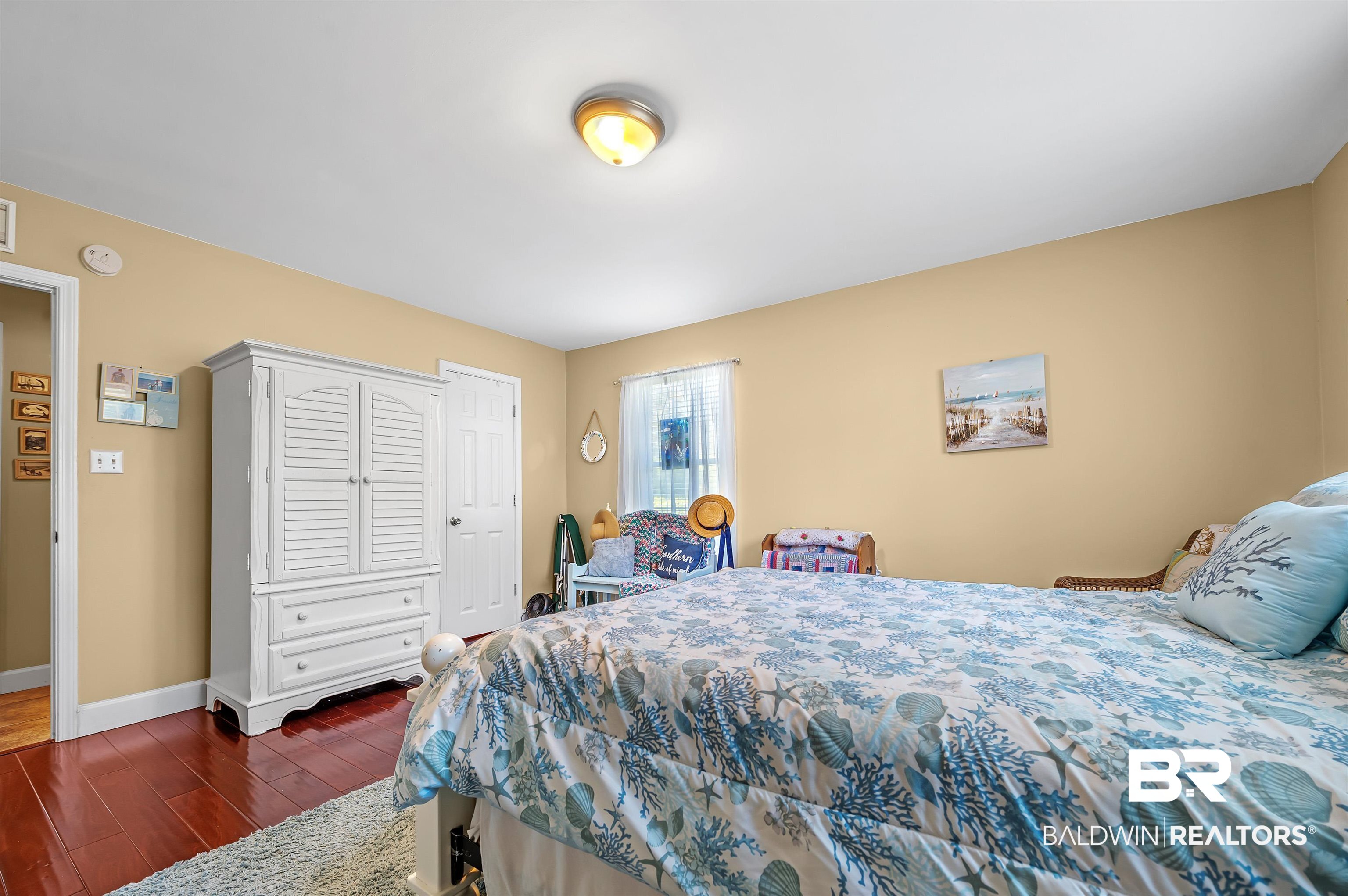 9901 Glover Court Fairhope, AL 36532 - Photo 27 of 52 Bedroom with dark hardwood / wood-style floors