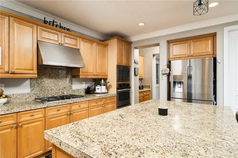 a kitchen with granite countertop a sink and a window
