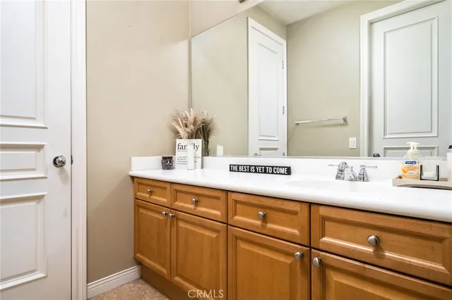 a bathroom with a sink a vanity and a mirror