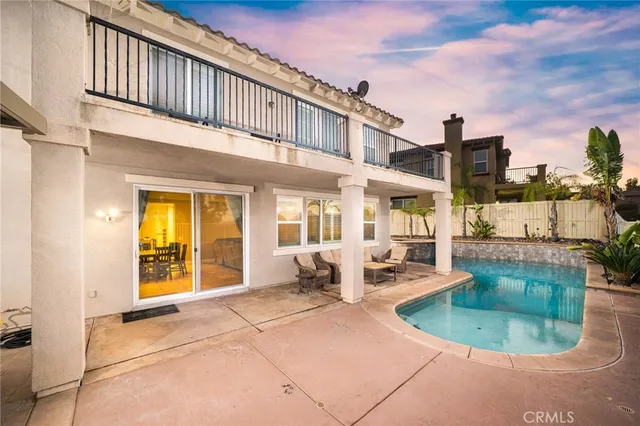 a view of a patio with couches table and chairs and potted plants