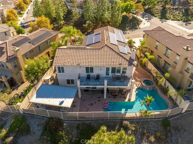 an aerial view of a city with lots of residential buildings ocean and mountain view