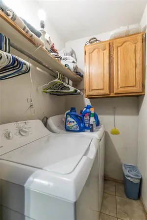 a bathroom with a granite countertop toilet sink and mirror
