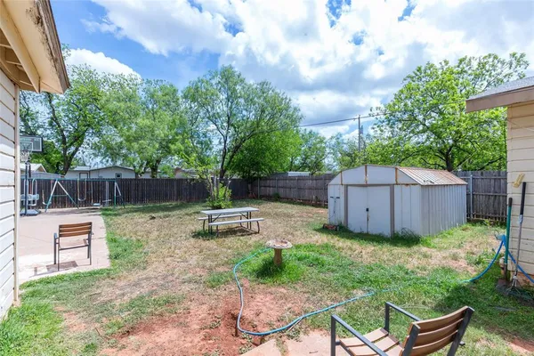 a swimming pool with outdoor seating and yard