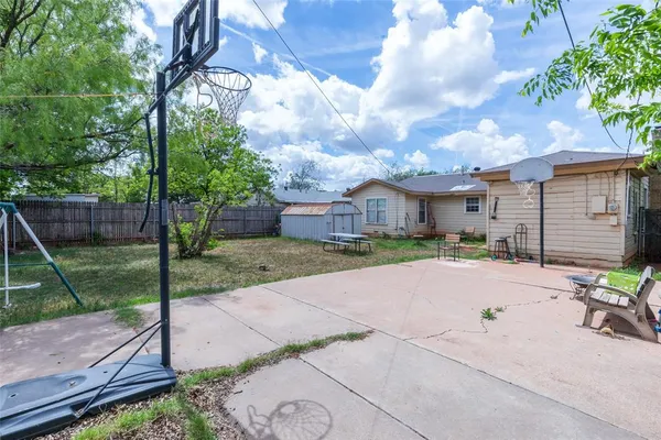 a view of a backyard with a fire pit and furniture