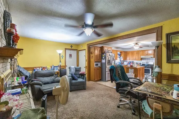 a living room with furniture a flat screen tv and a floor to ceiling window