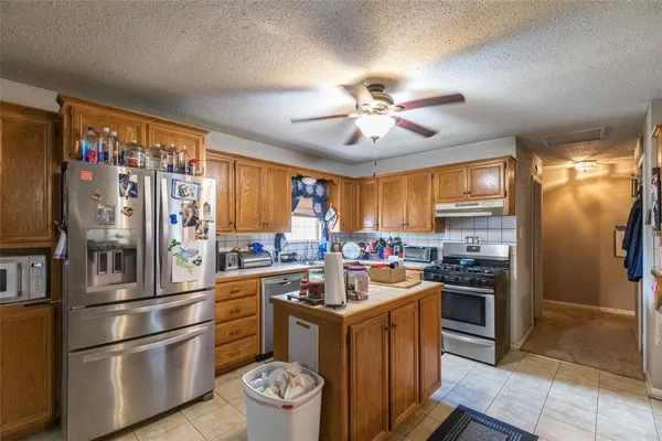a kitchen with a refrigerator a stove a sink and dishwasher