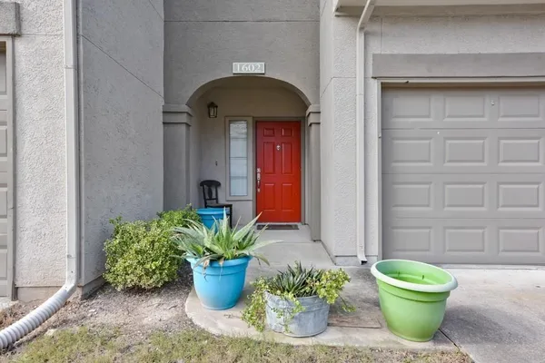 a front view of a house with potted plants