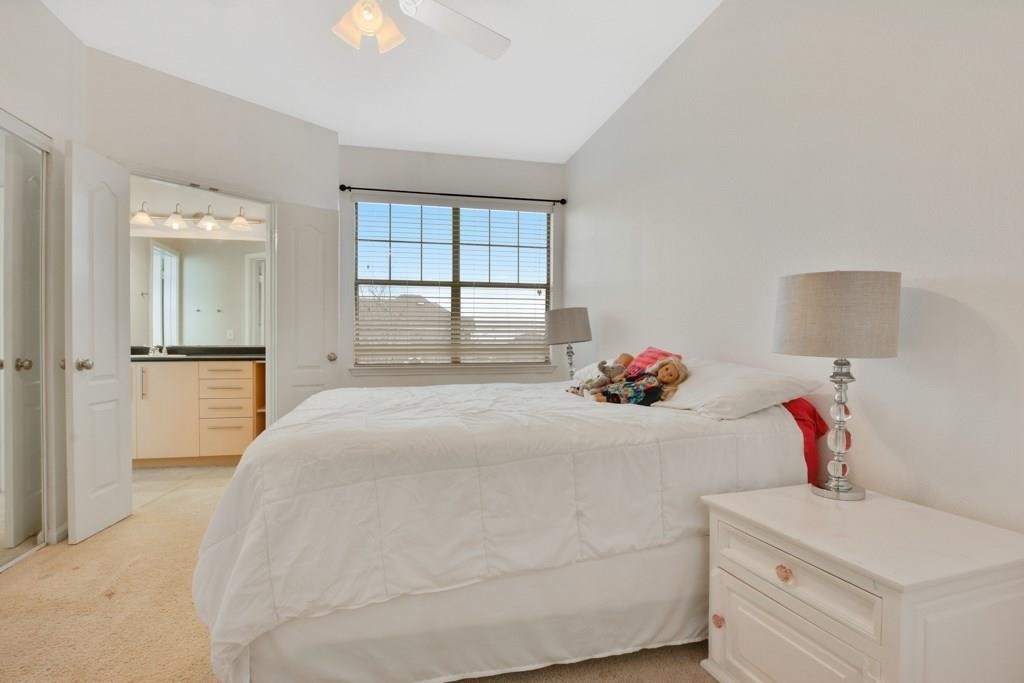 11203 Ranch Road 2222, Unit 1602 Austin, TX 78732 - Photo 12 of 25 a bedroom with a bed and a chandelier