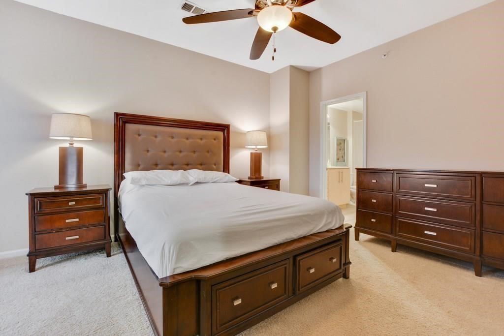 11203 Ranch Road 2222, Unit 1602 Austin, TX 78732 - Photo 14 of 25 a bedroom with a bed and a dresser