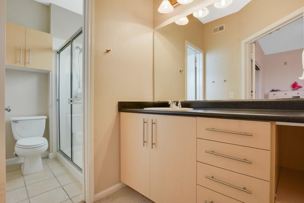 11203 Ranch Road 2222, Unit 1602 Austin, TX 78732 - Photo 15 of 25 a bathroom with a sink a toilet and a mirror