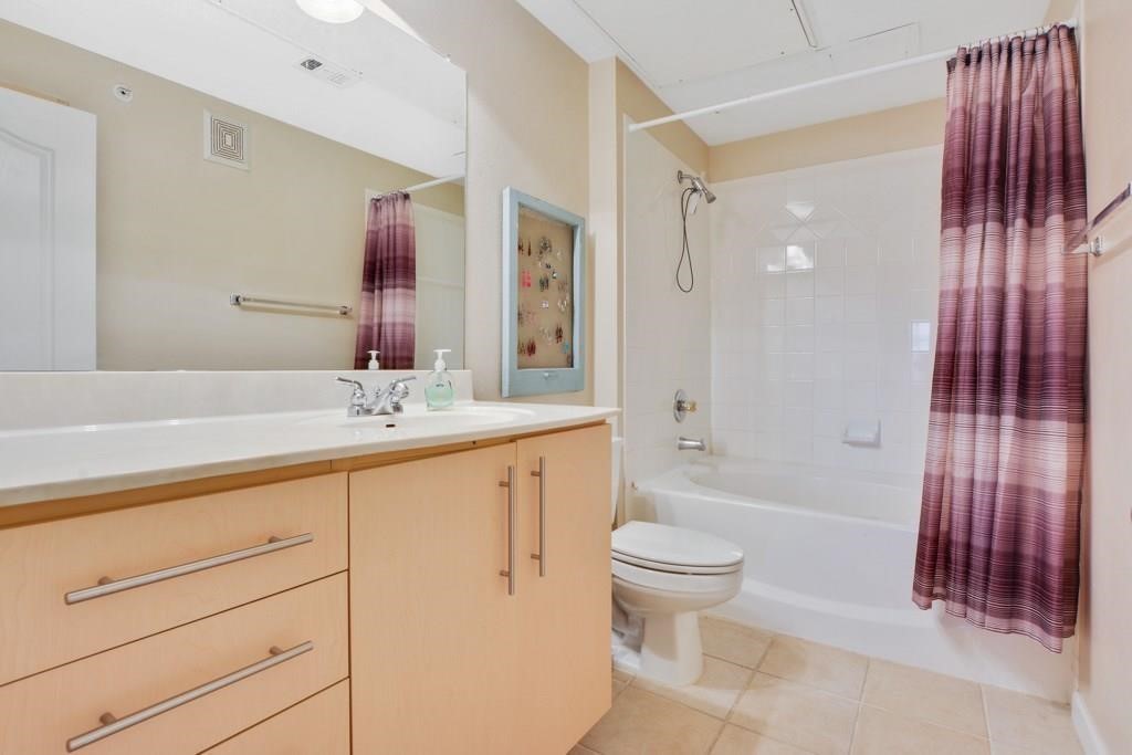 11203 Ranch Road 2222, Unit 1602 Austin, TX 78732 - Photo 18 of 25 a bathroom with a sink a toilet and shower