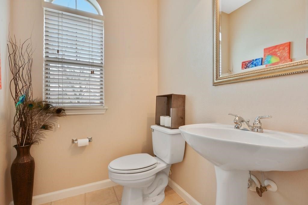 11203 Ranch Road 2222, Unit 1602 Austin, TX 78732 - Photo 19 of 25 a bathroom with a sink a toilet and mirror