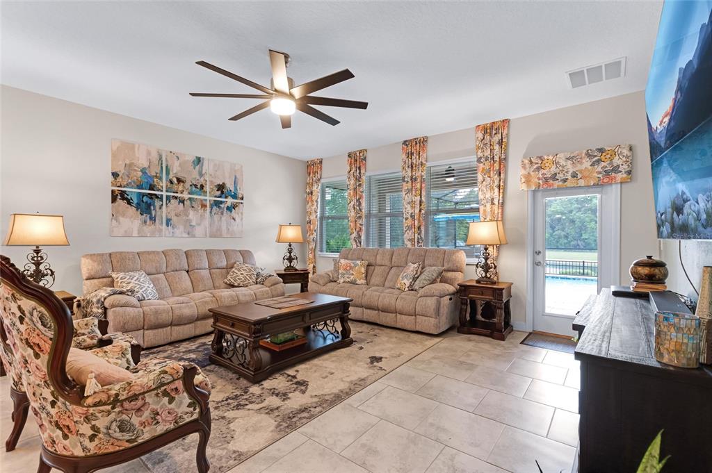 1089 Blackwolf Run Road Davenport, FL 33896 - Photo 16 of 82 a living room with furniture and a large window