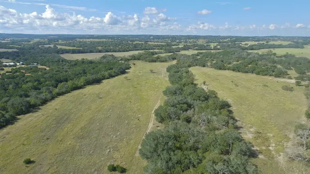 a view of a lake in a field