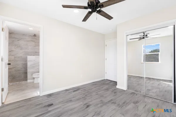 a view of an empty room with wooden floor