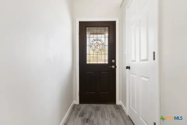 a view of a hallway with wooden floor