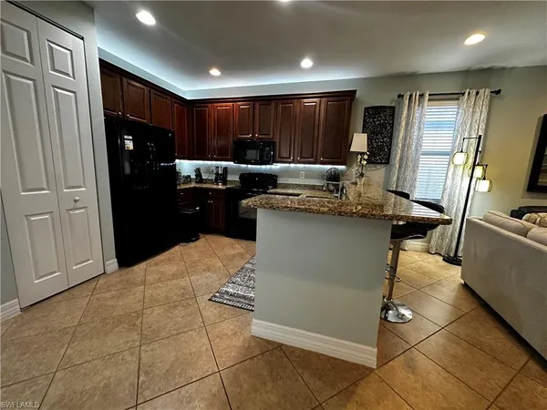 a kitchen with stainless steel appliances granite countertop a refrigerator and a stove