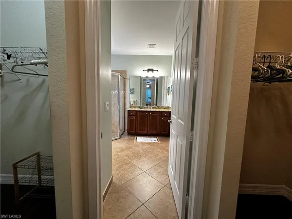 a view of a hallway and a livingroom with furniture