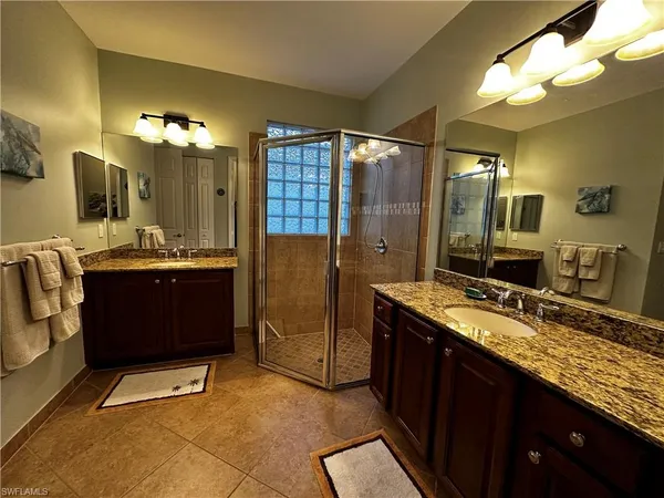 a bathroom with a sink double vanity and a mirror