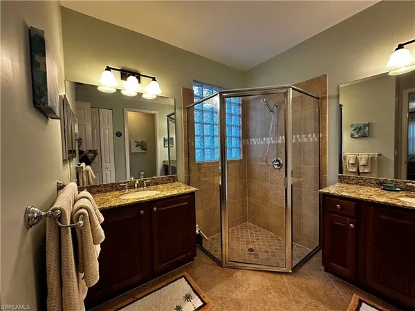a view of a bathroom sink shower and mirror
