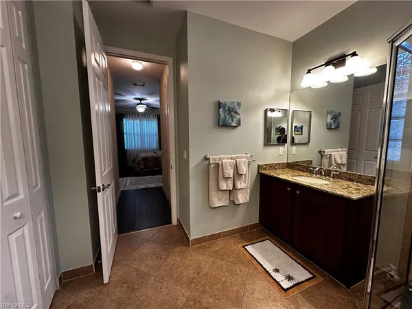 a spacious bathroom with a sink a mirror and a shower