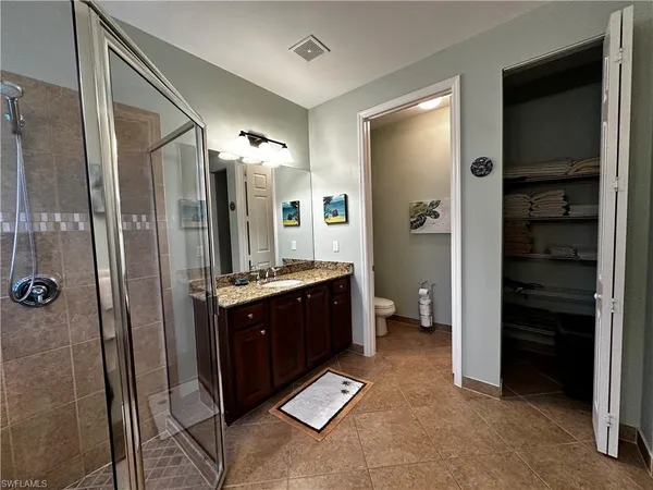 a spacious bathroom with a mirror and a shower