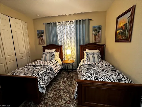 a bedroom with a bed and a painting on the wall