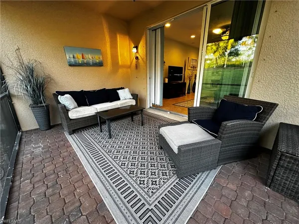 a balcony with furniture and a rug
