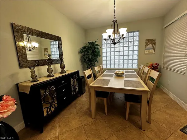 a dining room with furniture and window