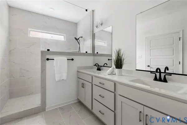 a bathroom with double sink and a mirror