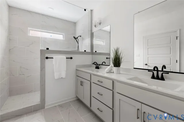 a bathroom with double sink and a mirror