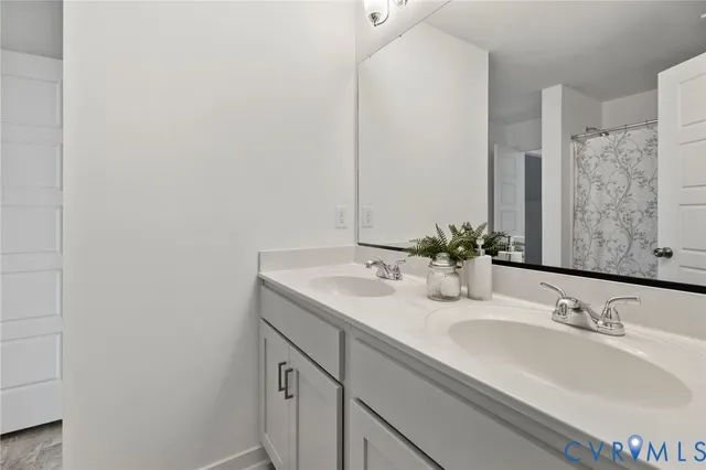 a front view of a house with a garden and trees