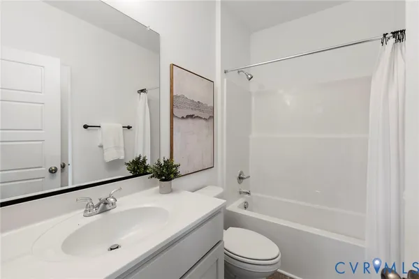 a bathroom with a sink a mirror toilet and bathtub