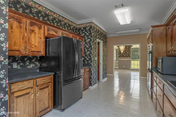 a kitchen with stainless steel appliances granite countertop a refrigerator and a sink