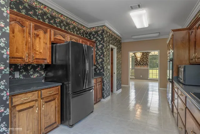 a kitchen with stainless steel appliances granite countertop a refrigerator and a sink