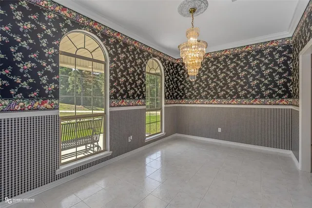 a view of a chandelier and a fireplace in a room