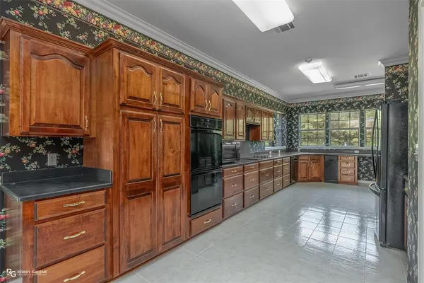 a kitchen with stainless steel appliances granite countertop a refrigerator and cabinets