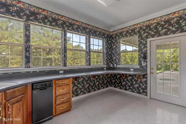 a kitchen with a sink and large window