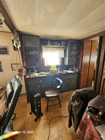 a room with a couch chairs and windows