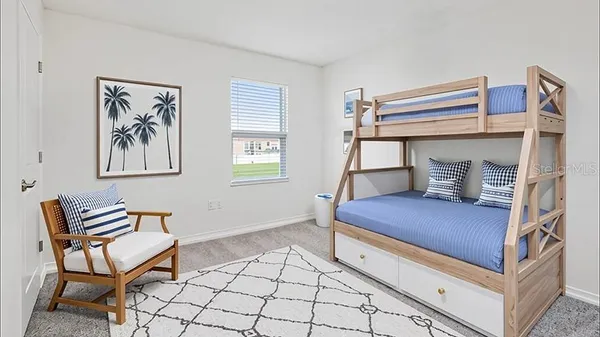 a bedroom with a bunk bed and a chair