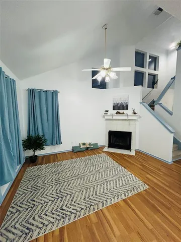 a kitchen with granite countertop a stove and a wooden floor