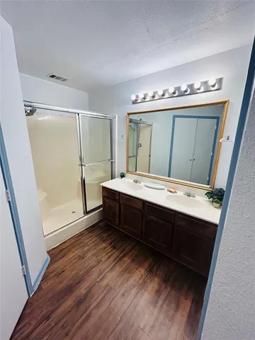 a bathroom with a double vanity sink and mirror